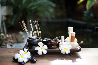 Close-up of flowers and equipment on table