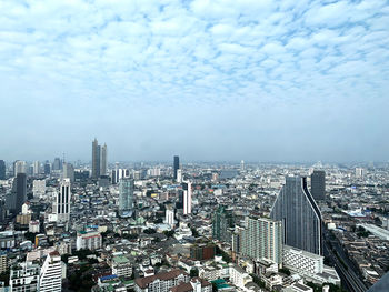 High angle view of modern buildings in city against sky