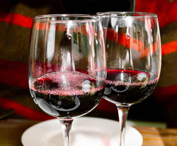 Two glasses with red wine close-up on a dark background