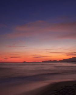 Scenic view of sea against romantic sky at sunset