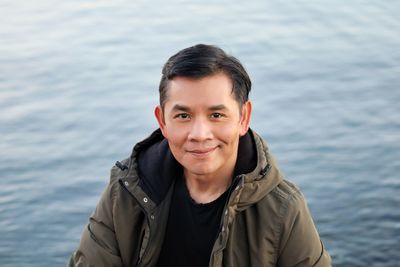 Portrait of young man standing in sea