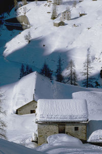 Snow covered field by building