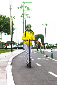 Portrait of man riding motorcycle on road