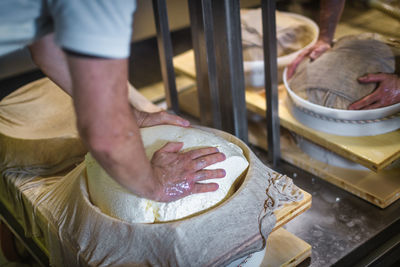 Preparation of cheese wheels in a dairy in northern italy