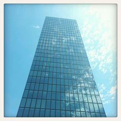 Low angle view of modern building against blue sky