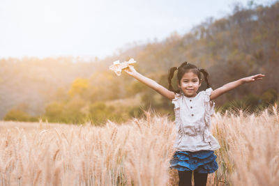 Girl playing in wheat field