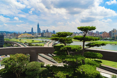 View of buildings in city against cloudy sky