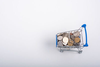 High angle view of coins on white background