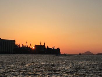 Scenic view of sea against clear sky during sunset