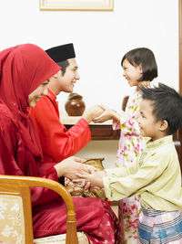 Family holding hands at home during celebration