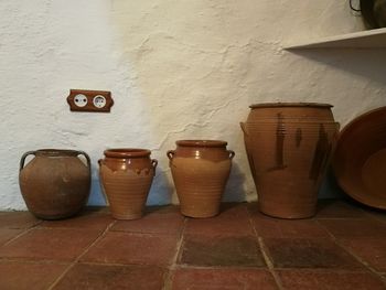 View of wine glasses on tiled floor against wall