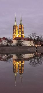 Reflection of building in lake at dusk