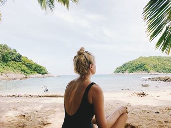 Rear view of woman looking at beach