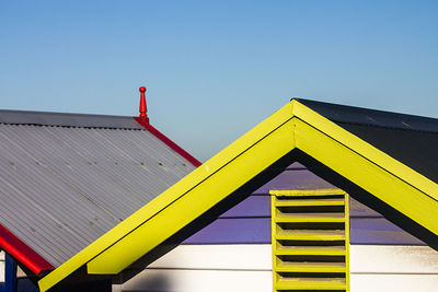 Low angle view of yellow building against clear sky
