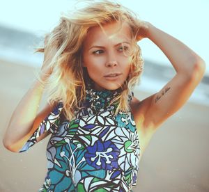 Close-up portrait of young woman at beach