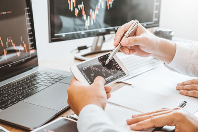 Midsection of man using laptop on table