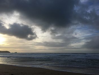 Scenic view of beach against sky during sunset