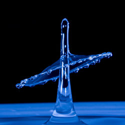 Close-up of water splashing against black background