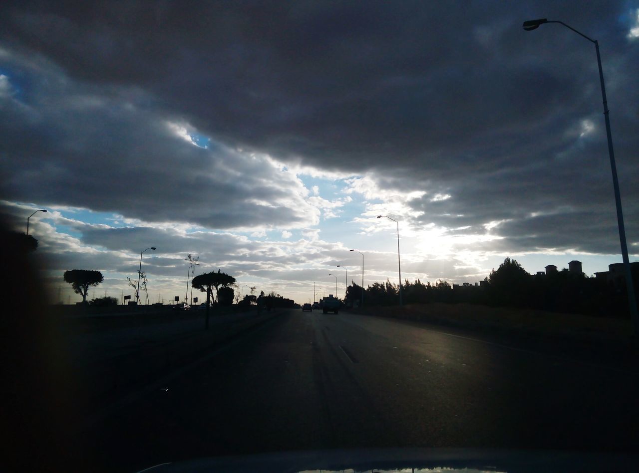 sky, cloud - sky, transportation, cloudy, road, the way forward, street light, cloud, silhouette, car, diminishing perspective, weather, street, dusk, overcast, nature, electricity pylon, vanishing point, storm cloud, road marking