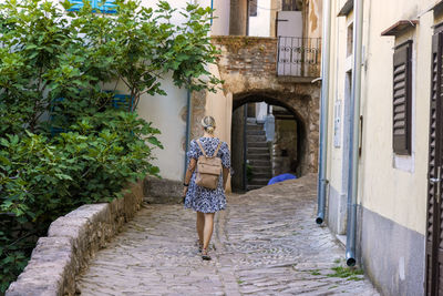 Rear view of woman walking on street