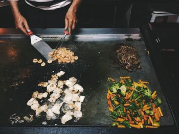 Midsection of chef preparing food in kitchen