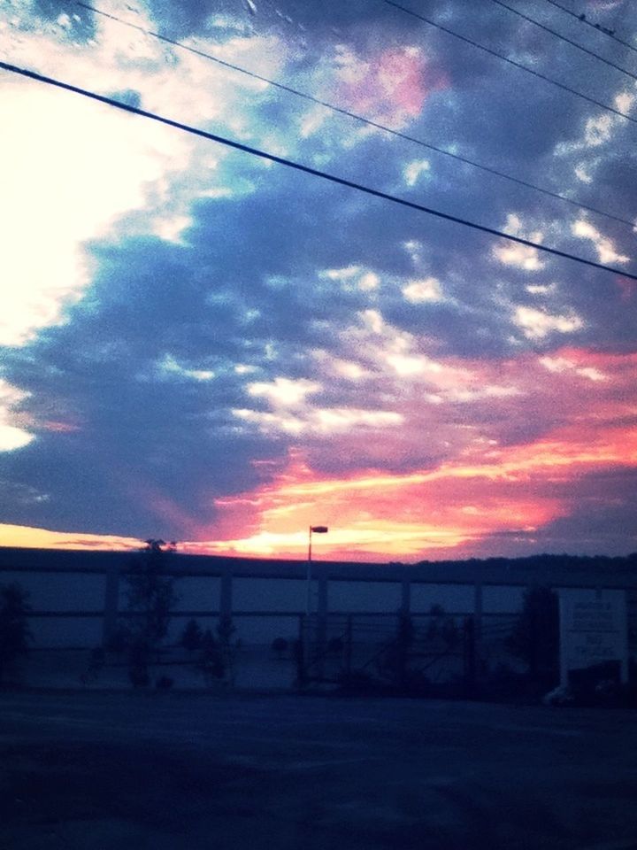 sunset, sky, cloud - sky, orange color, power line, cloud, cloudy, connection, silhouette, cable, electricity pylon, tranquil scene, tranquility, scenics, landscape, fence, beauty in nature, dramatic sky, nature, built structure