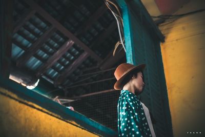 Woman standing against wall