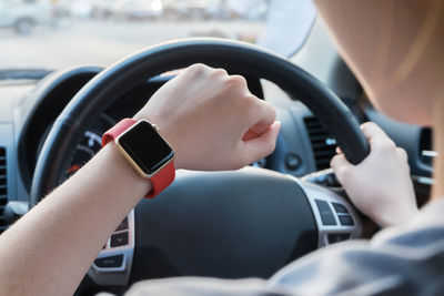 Cropped image of woman driving car