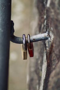 Close-up of padlocks hanging on railing