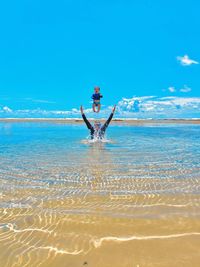 Man surfing in sea against sky