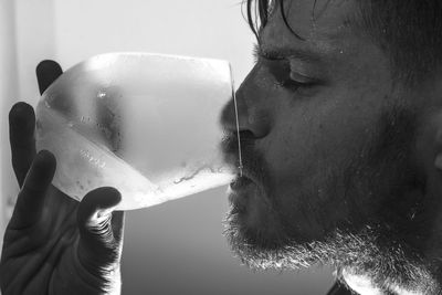 Close-up of man drinking cold water