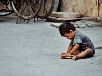 Side view of boy playing with toy