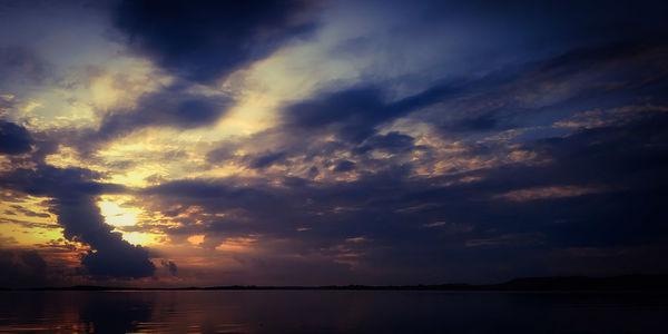 Scenic view of lake against sky at sunset