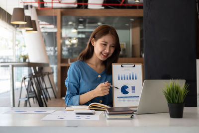 Businesswoman talking on video call at office