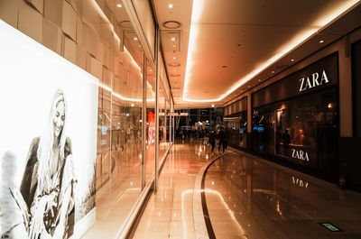 People in illuminated underground walkway