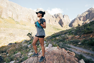 Full length of woman standing on mountain