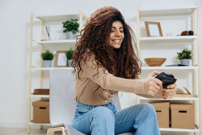 Happy woman playing video game