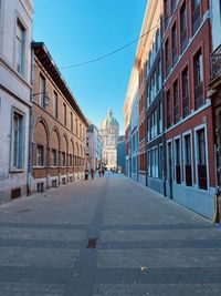 Street amidst buildings against sky