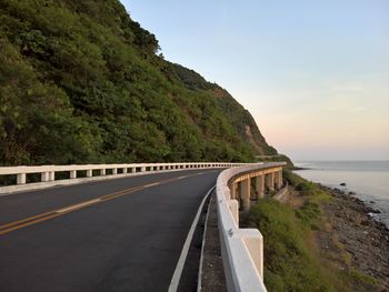 Road by sea against sky