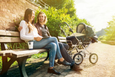 Woman sitting on bench in park