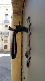 Close-up of old metal door of building