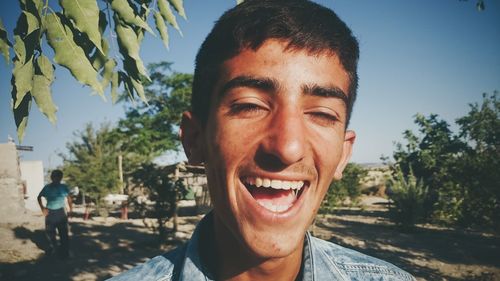 Portrait of smiling man against trees