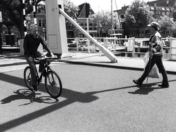 People riding bicycle on railroad track