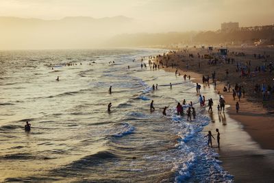 People enjoying summer sunset at beach