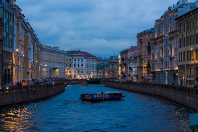 Boats in canal in city