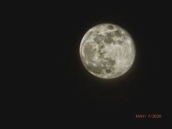 Low angle view of moon against sky at night