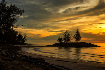 Scenic view of sea against orange sky