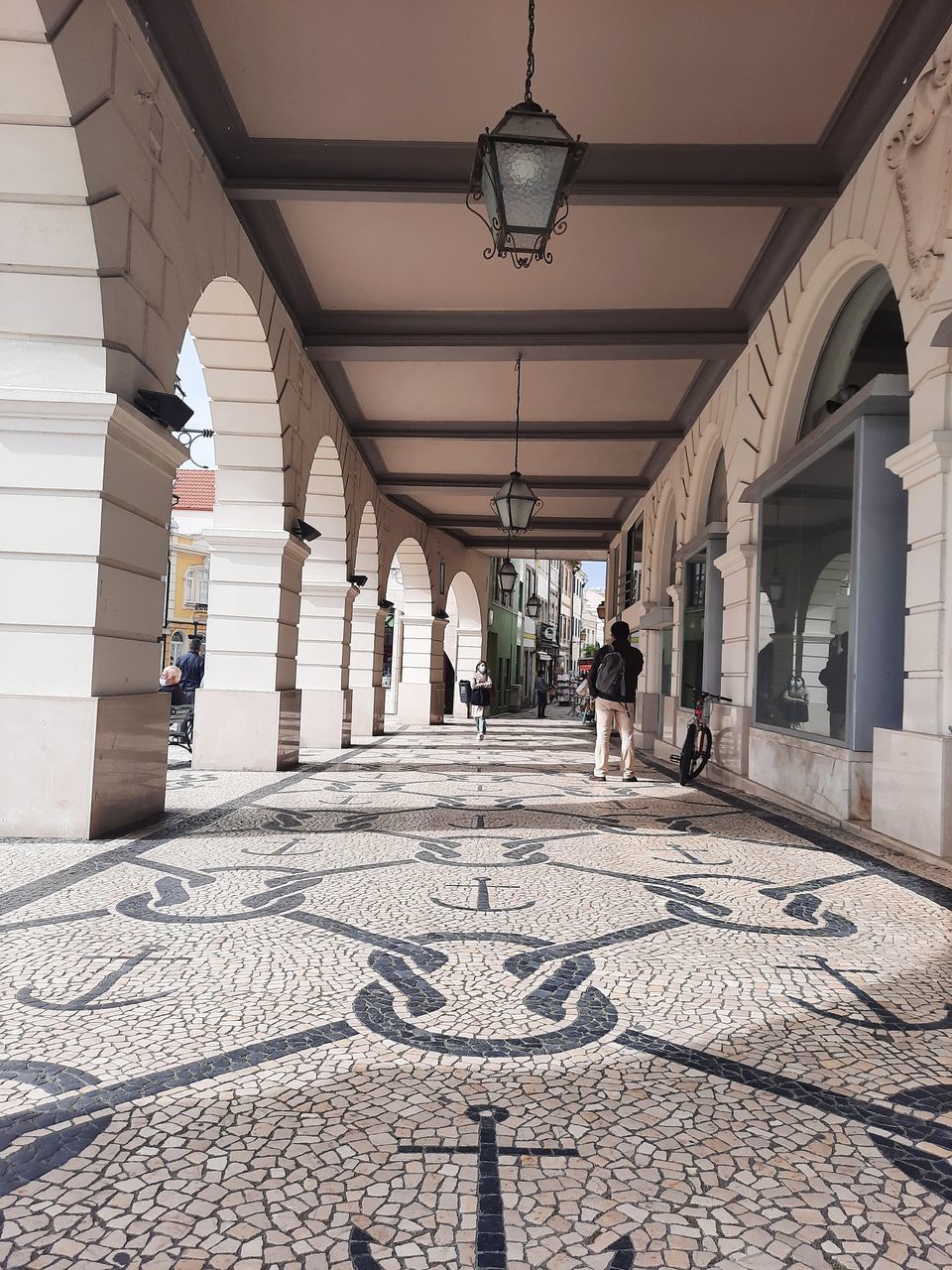 PEOPLE WALKING ON CORRIDOR OF BUILDING