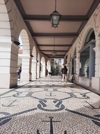 People walking on street amidst buildings