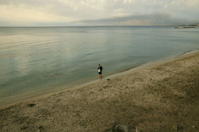 Man looking at sea against sky